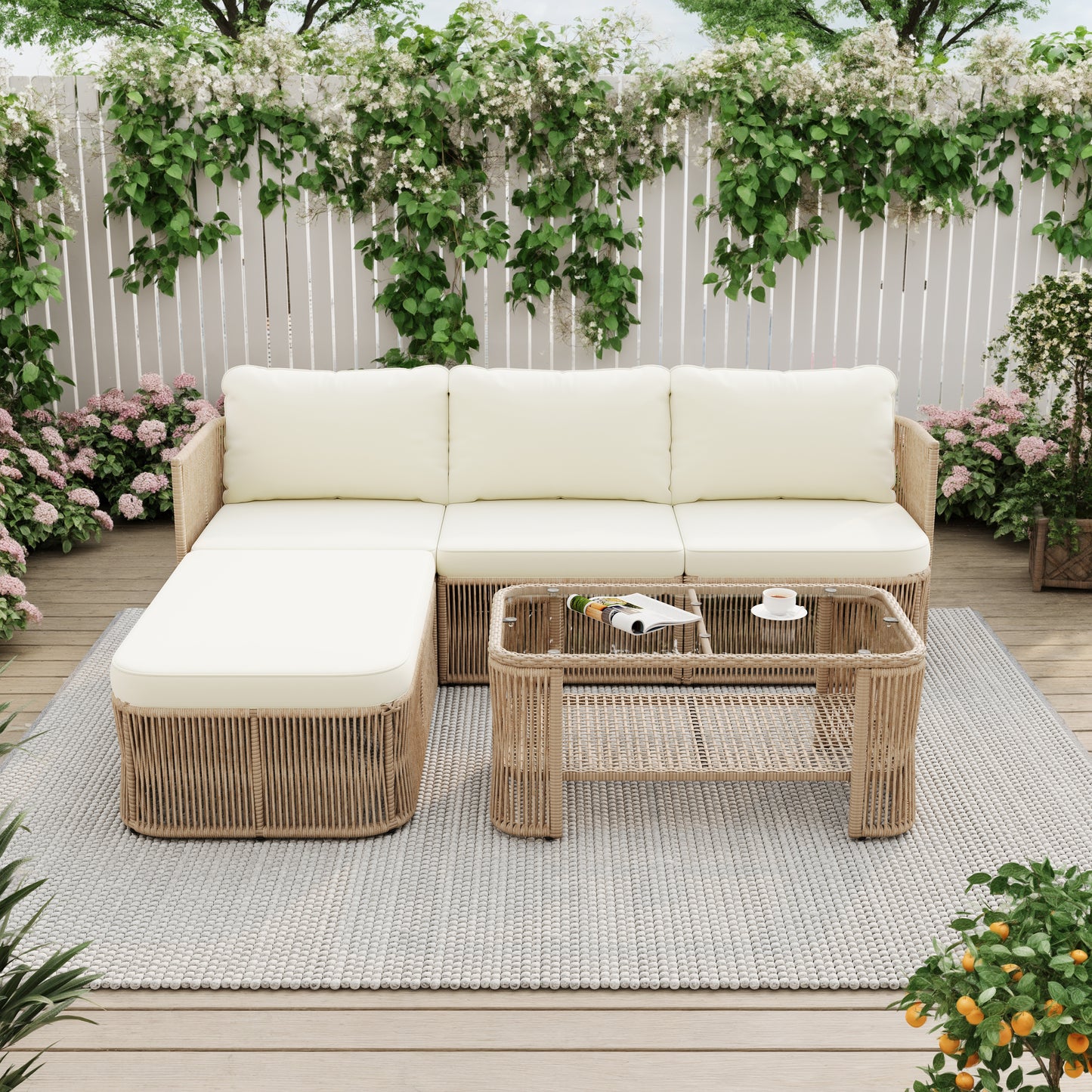 Alba outdoor sofa and two chairs arranged around the glass-top table